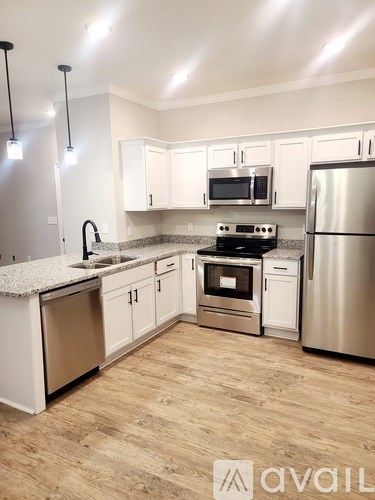 A kitchen with white cabinets and stainless steel appliances.