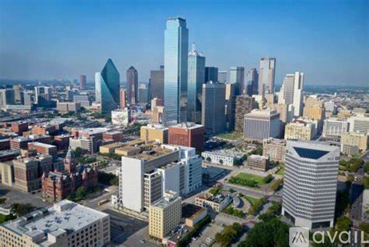 A cityscape with a variety of buildings, including a tall blue skyscraper.
