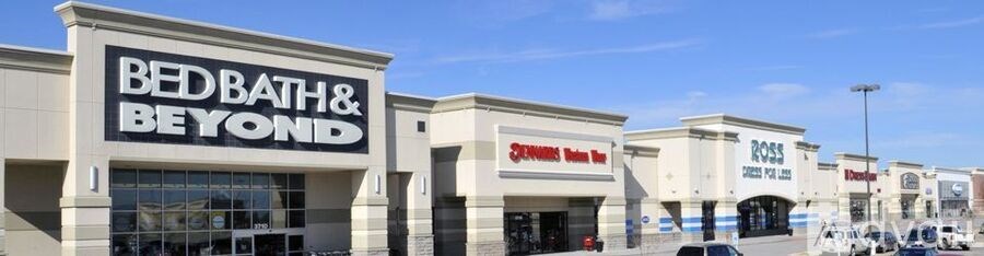 A Bed Bath and Beyond store is located in a strip mall.