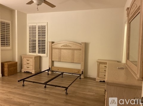 A bedroom with a bed, dresser, and nightstand.