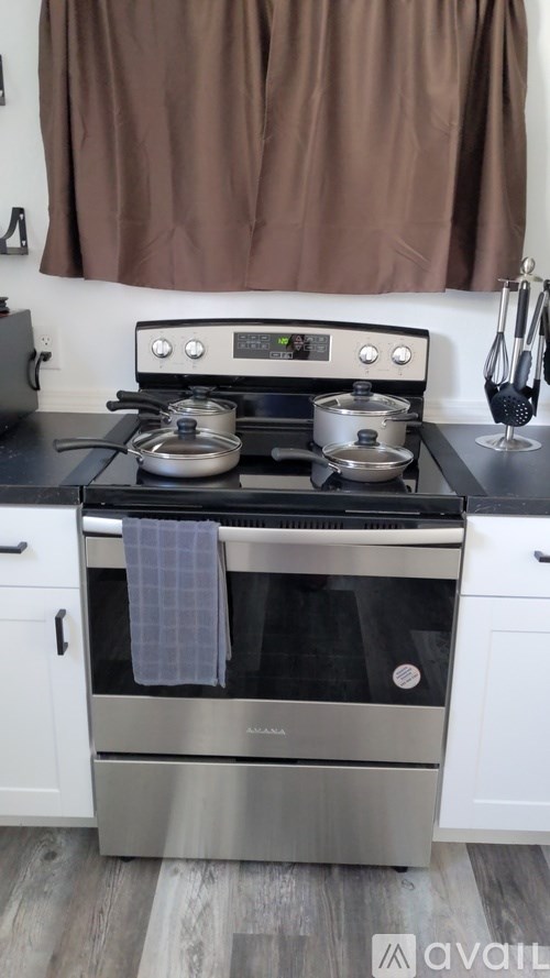 A modern stove top with two pots on it.