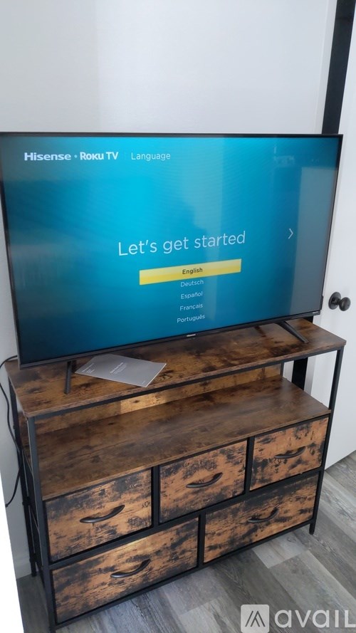 A Hisense TV screen is on with a language selection screen.