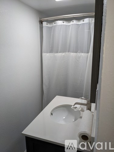 A white sink in a small bathroom.