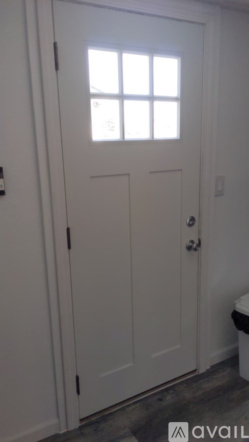 A white door with a window above it.