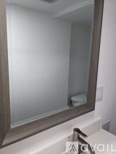 A bathroom with a mirror and a sink.