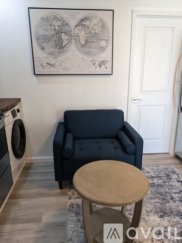 A blue sofa with a wooden table in front of it.