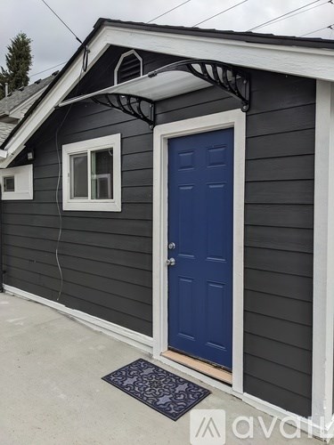 A small house with a blue door and a window.