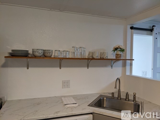 A kitchen with a marble countertop and a sink.