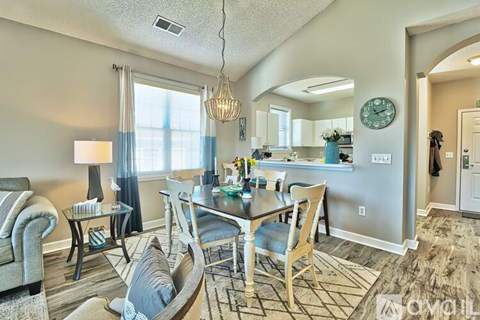 A living room with a dining table and chairs.
