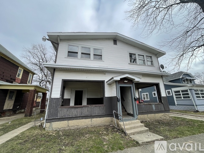 A two-story house with a garage is for sale.