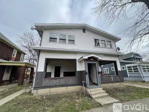 A two-story house with a garage is for sale.