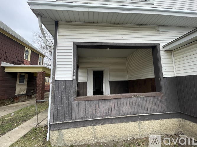 A house with a window and a door is for sale.