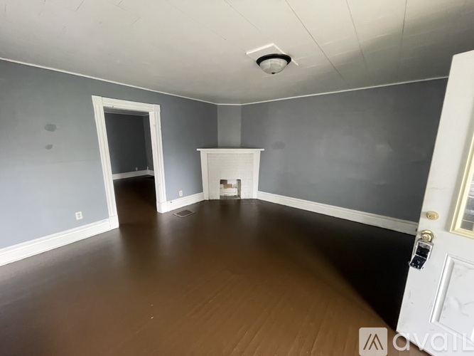 A room with a white door and a window.