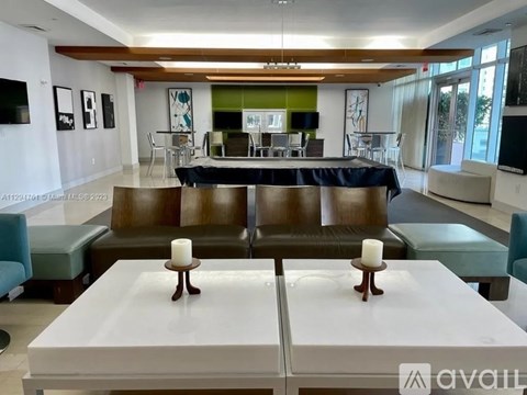 A living room with a white table and brown chairs.