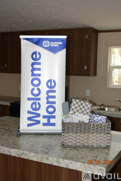 A welcome home sign is displayed in a kitchen.