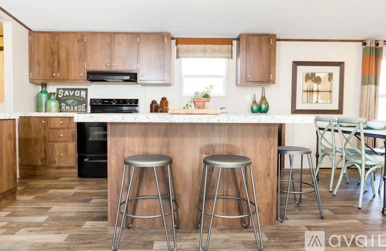 A kitchen with wooden cabinets and a black oven.