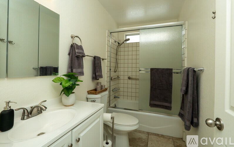 A bathroom with a white sink, toilet, and bathtub.