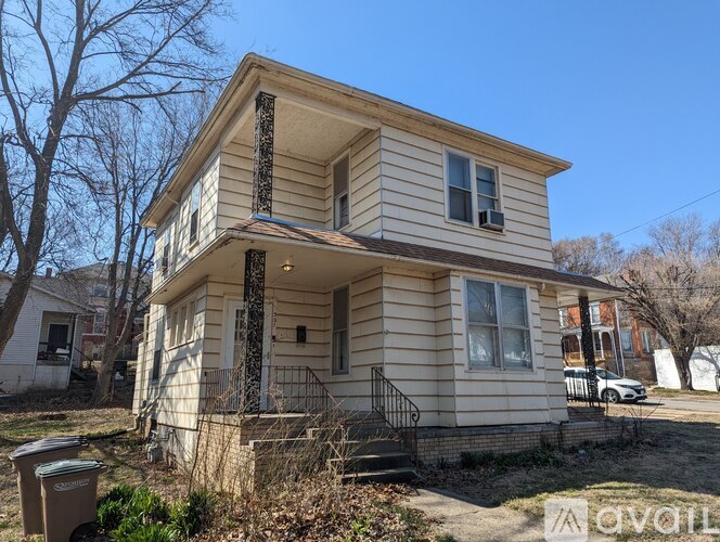 A two-story house with a balcony on the second floor.