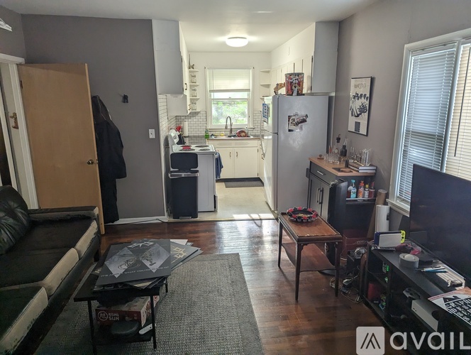 A living room with a couch, a coffee table, and a television.
