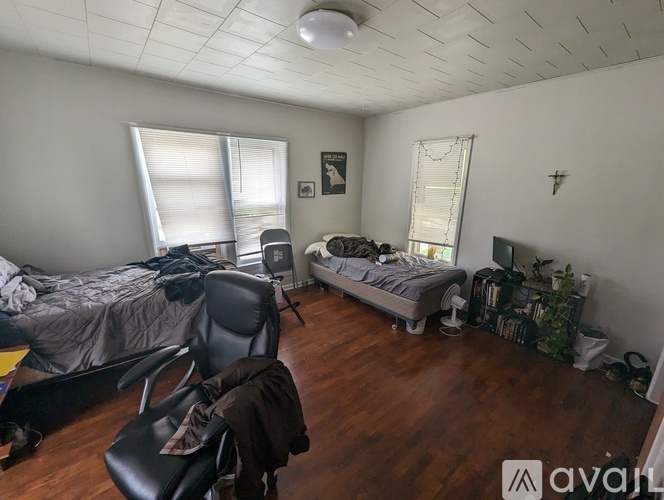 A room with a bed, a chair, and a desk.