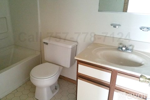 A white toilet sits next to a sink in a bathroom.