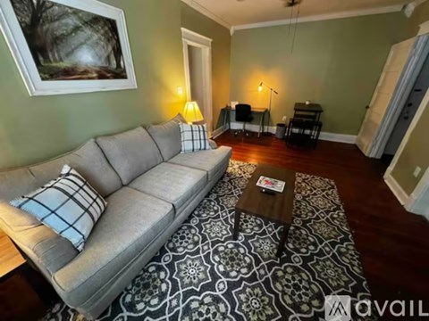 A living room with a grey sofa and a coffee table.