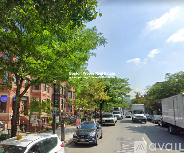 A street view with cars and trucks on a sunny day.