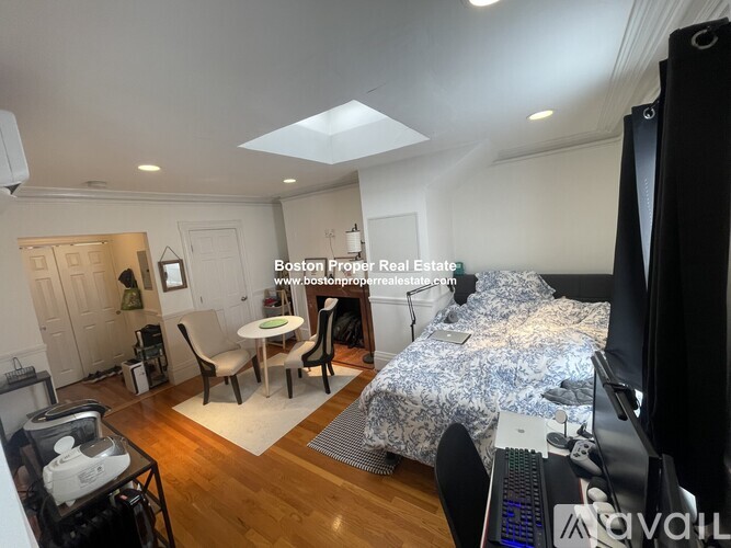 A bedroom with a bed, desk, and chair is shown in the image.