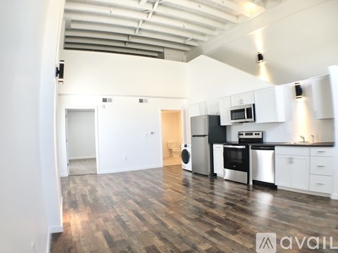 A kitchen with white cabinets and a black stove top oven.