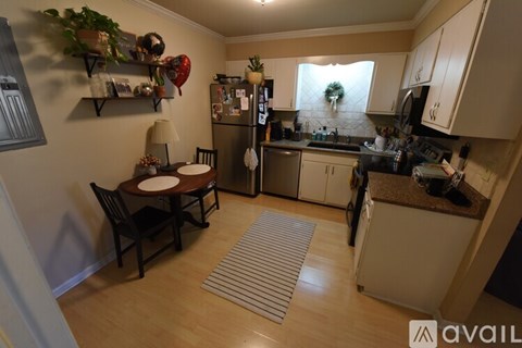 A kitchen with a table and chairs in the middle of the room.