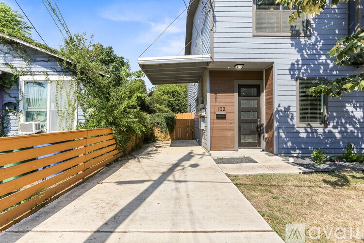A house with a grey exterior and a black gate.