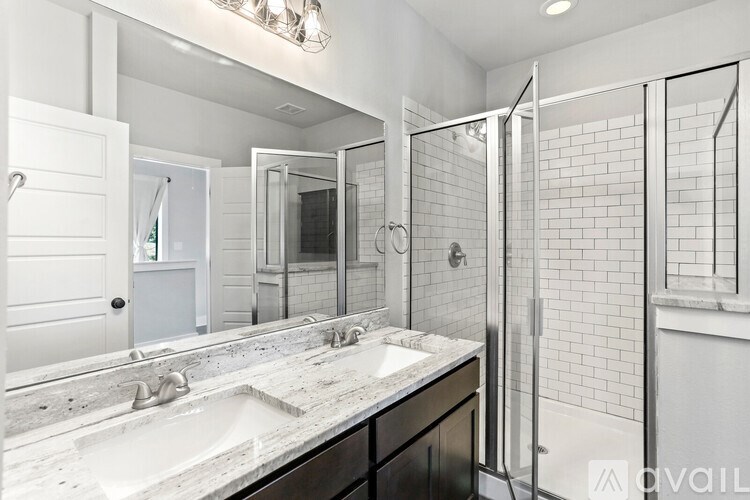 A hallway with a door at the end and two shelves on either side.