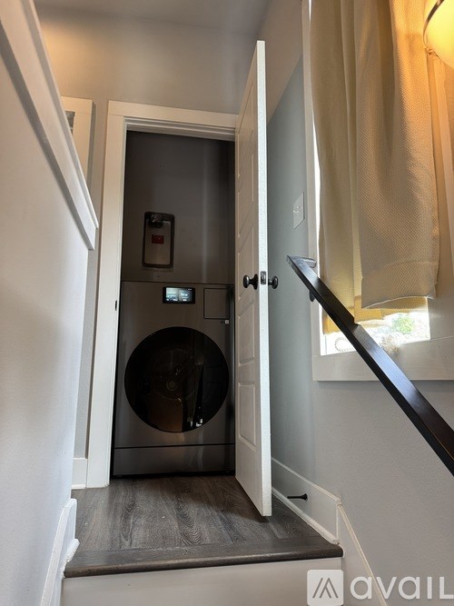 A washing machine is in a small room.