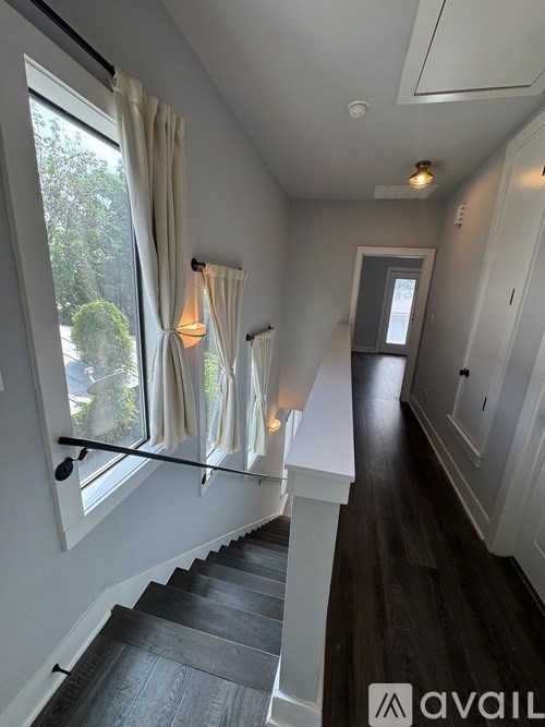 A hallway with a staircase leading to the second floor.