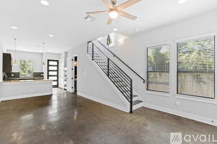 A kitchen with dark brown cabinets and a granite countertop.