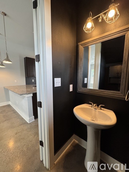 A bathroom with a sink and mirror.
