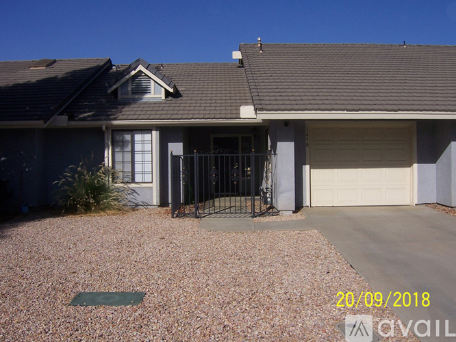 A house with a garage door is for sale.
