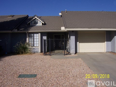 A house with a garage door is for sale.