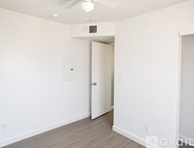 A room with a wall that says "Unit 2 (2 bed/1 bath) white appliances".