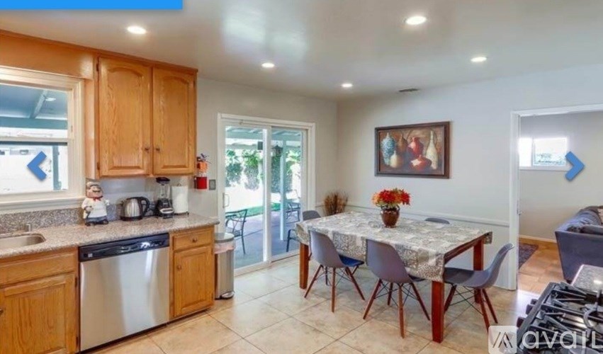 A kitchen with a table and chairs in the middle of the room.