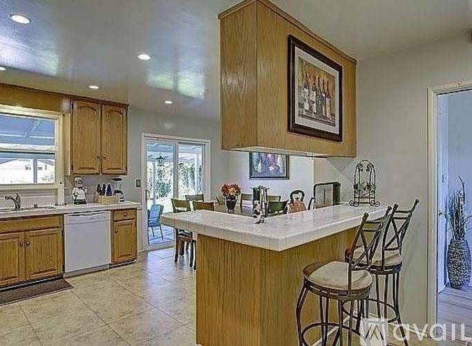 A kitchen with wooden cabinets and a white countertop.