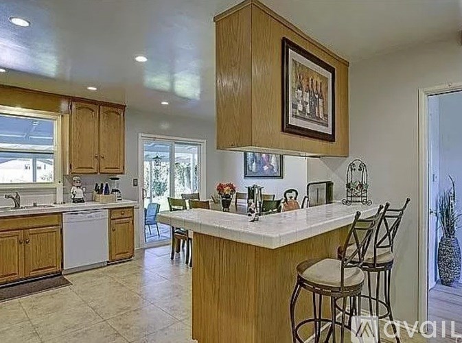 A kitchen with wooden cabinets and a white countertop.