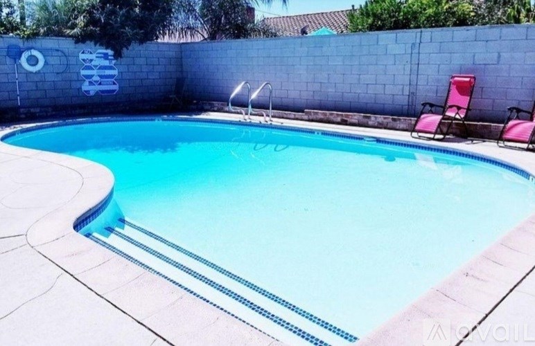 A small pool with a blue tiled edge and a white tiled floor.