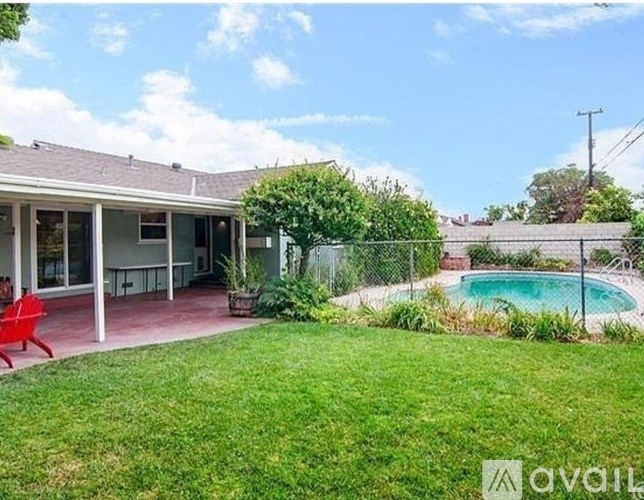 A house with a pool in the backyard.