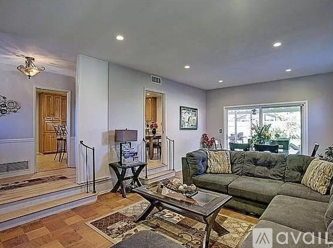 A living room with a grey couch and a coffee table.