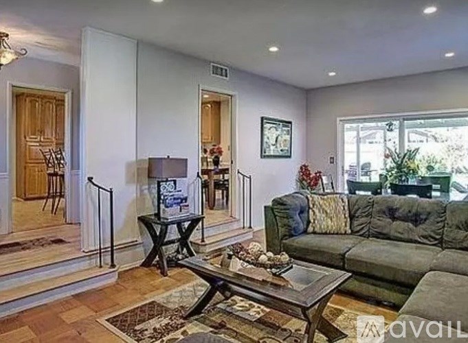 A living room with a green couch and a coffee table.