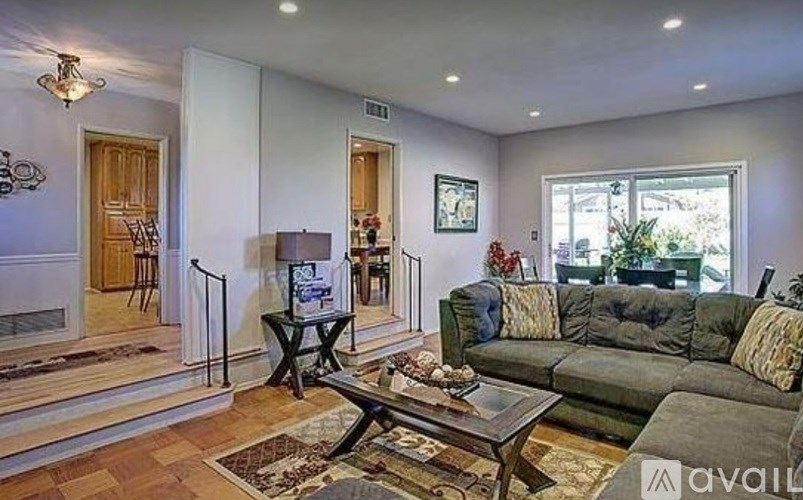 A living room with a couch, coffee table, and a fireplace.
