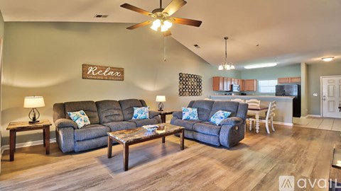 A living room with a grey sofa and a wooden coffee table.