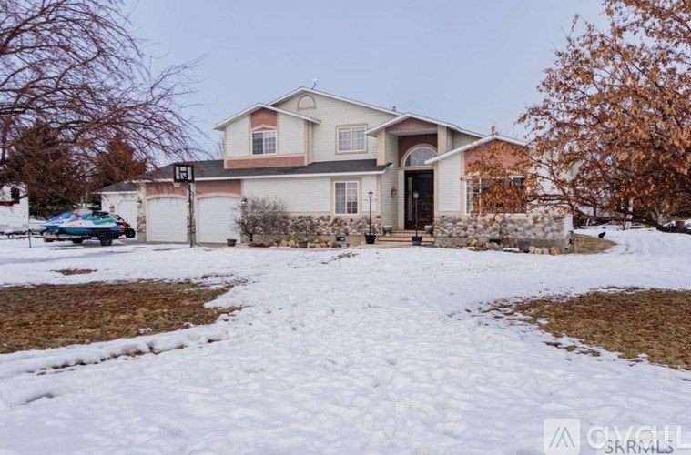 A house with a car parked in front of it.