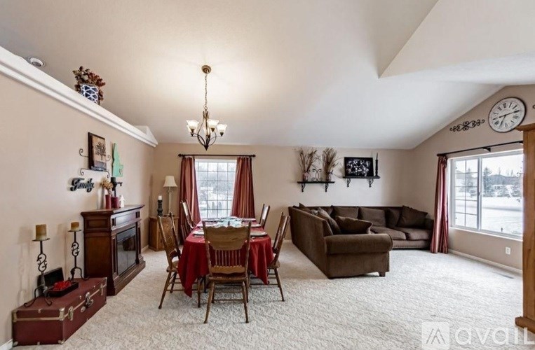 A living room with a dining table set up with chairs and a couch.